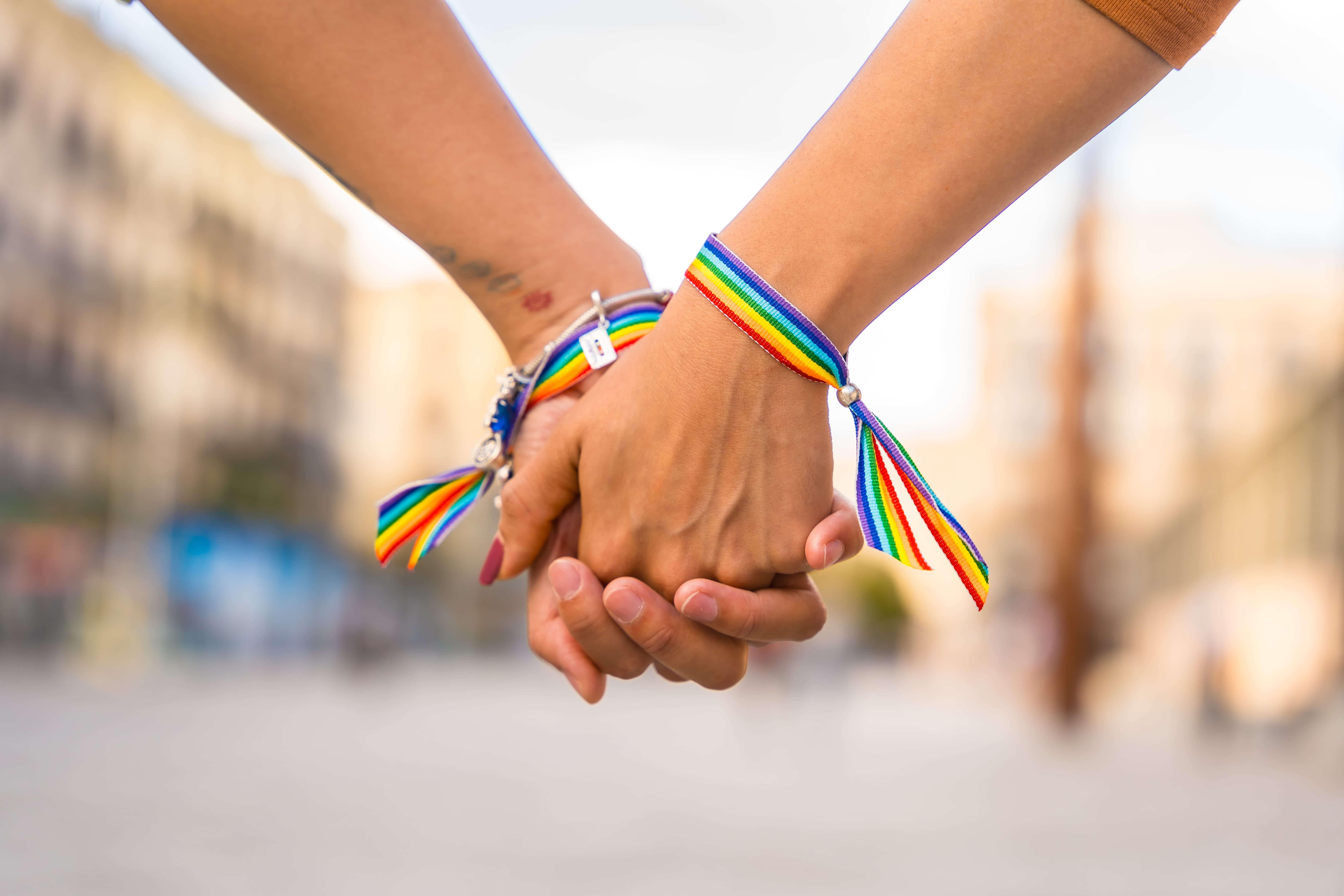 A closeup of two people holding hands